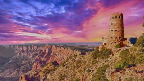 a sunset view of the Grand Canyon National Park with the Desert View Watch Tower in the foreground