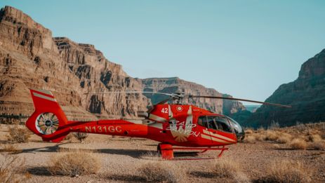 a red helicopter landed at the bottom of the Grand Canyon West