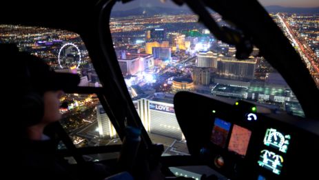 a Las Vegas Strip helicopter tour flying over the lit up casinos at night