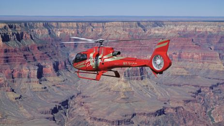 a Grand Canyon helicopter tour flies over a massive gorge located within the South Rim