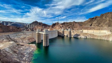 the blue water of the Colorado River with the Hoover Dam in the background