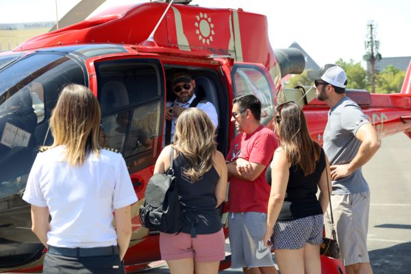 Tour group boarding a papillon helicopter for one of the best day trips from las vegas