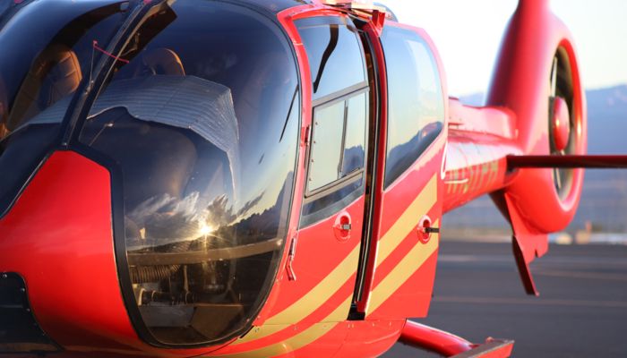 a close-up image of a red helicopter seen from the front