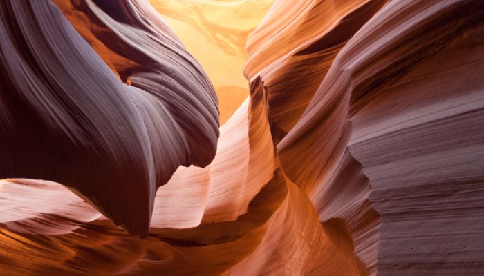 swirling orange rock formations found on the ceiling of antelope canyon
