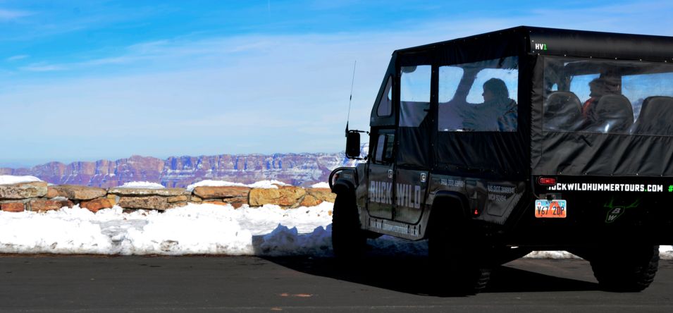 a military-style Hummer vehicle parked at the Grand Canyon during winter
