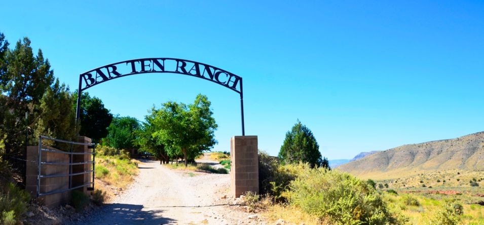 the entrance to Bar 10 Ranch seen with a large sign and trees nearby