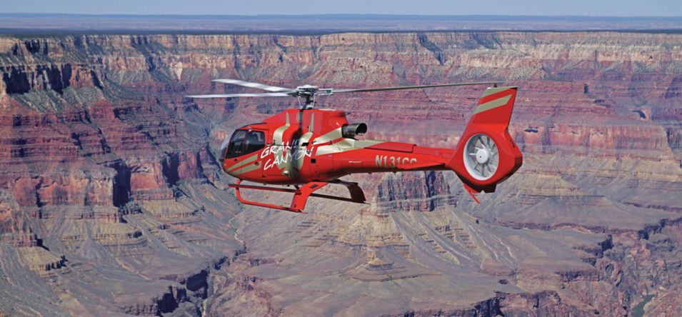 A Grand Canyon helicopter tour flies over the South Rim landscape
