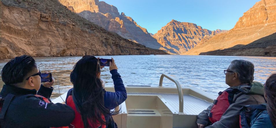 passengers on a pontoon boat on the colorado river taking photos