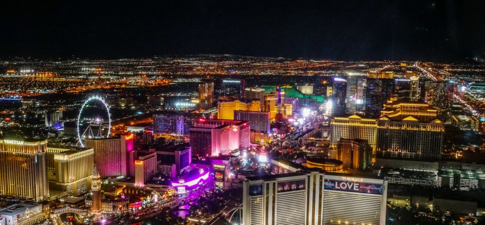 The colorful neon lights and signs across the Las Vegas Strip seen from a helicopter at night