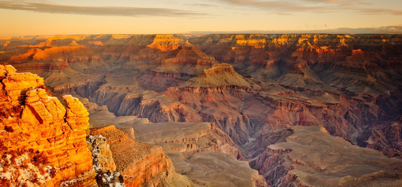 The Grand Canyon South Rim illuminated orange by the sunset