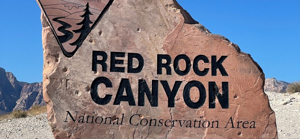a close-up photo of the Red Rock Canyon entrance sign made of stone