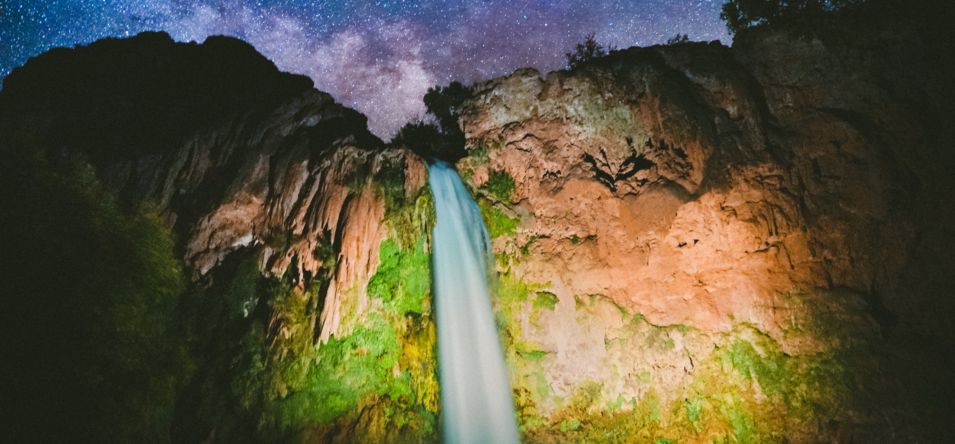 a long exposure shot of a Havasu Falls waterfall beneath a an incredible starscape