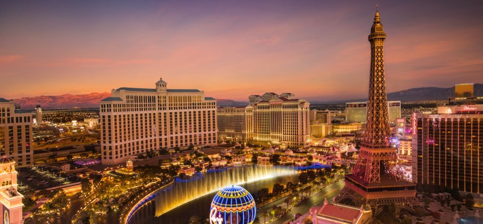 colorful sunset in las vegas with bellagio and paris hotel