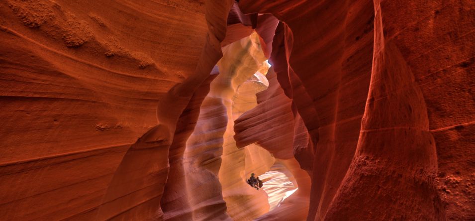 two guests sit within the depths of sandstone walls on an Antelope Canyon tour