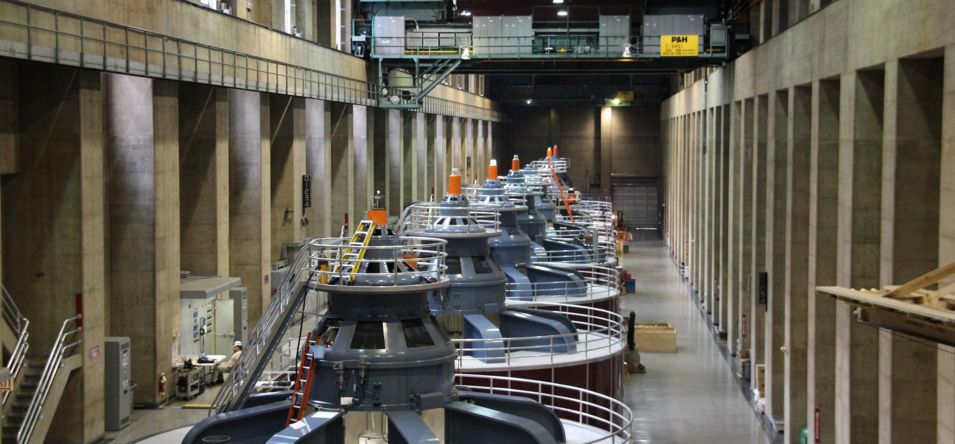 the interior of the Hoover Dam power plant displaying several large generators