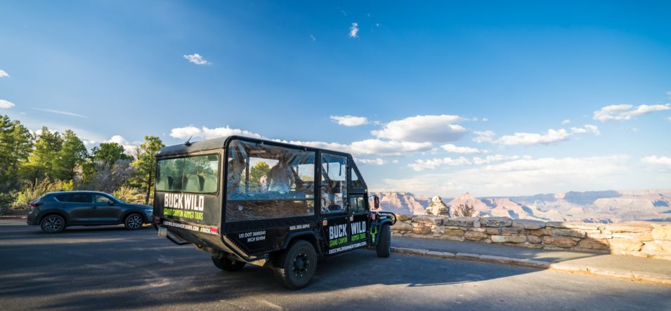 a Grand Canyon hummer tour parked at a scenic lookout point at the South Rim