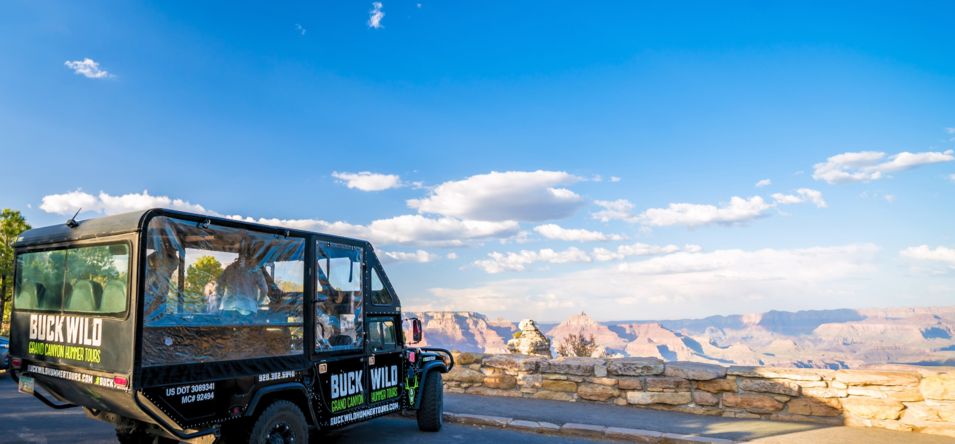 a military-style hummer vehicle parked at a Grand Canyon National Park lookout point