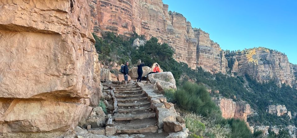 hikers stand atop a stone staircase within Grandview Trail at the Grand Canyon South Rim