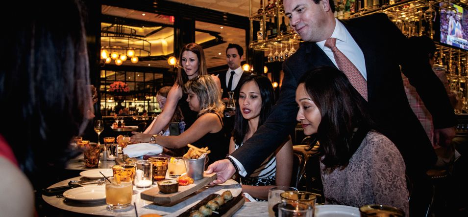 A group of diners are served a plate in a luxury Las Vegas restaurant