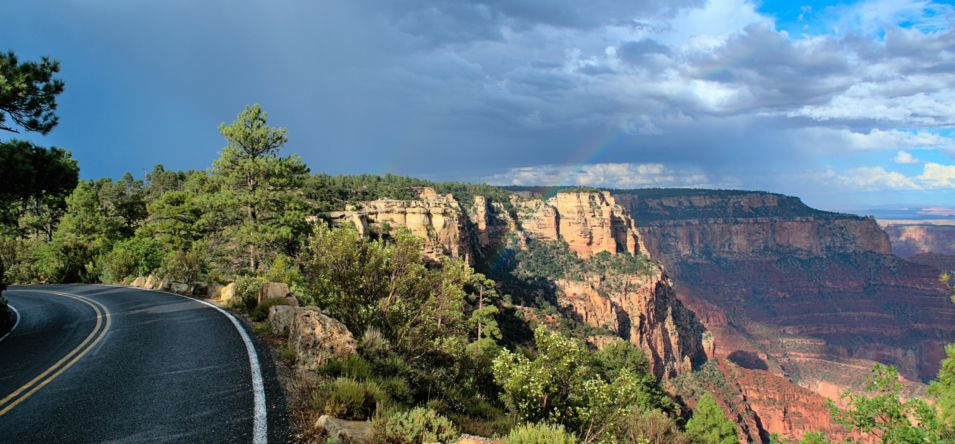 A road located along the rim of the Grand Canyon, seen on a cloudy day