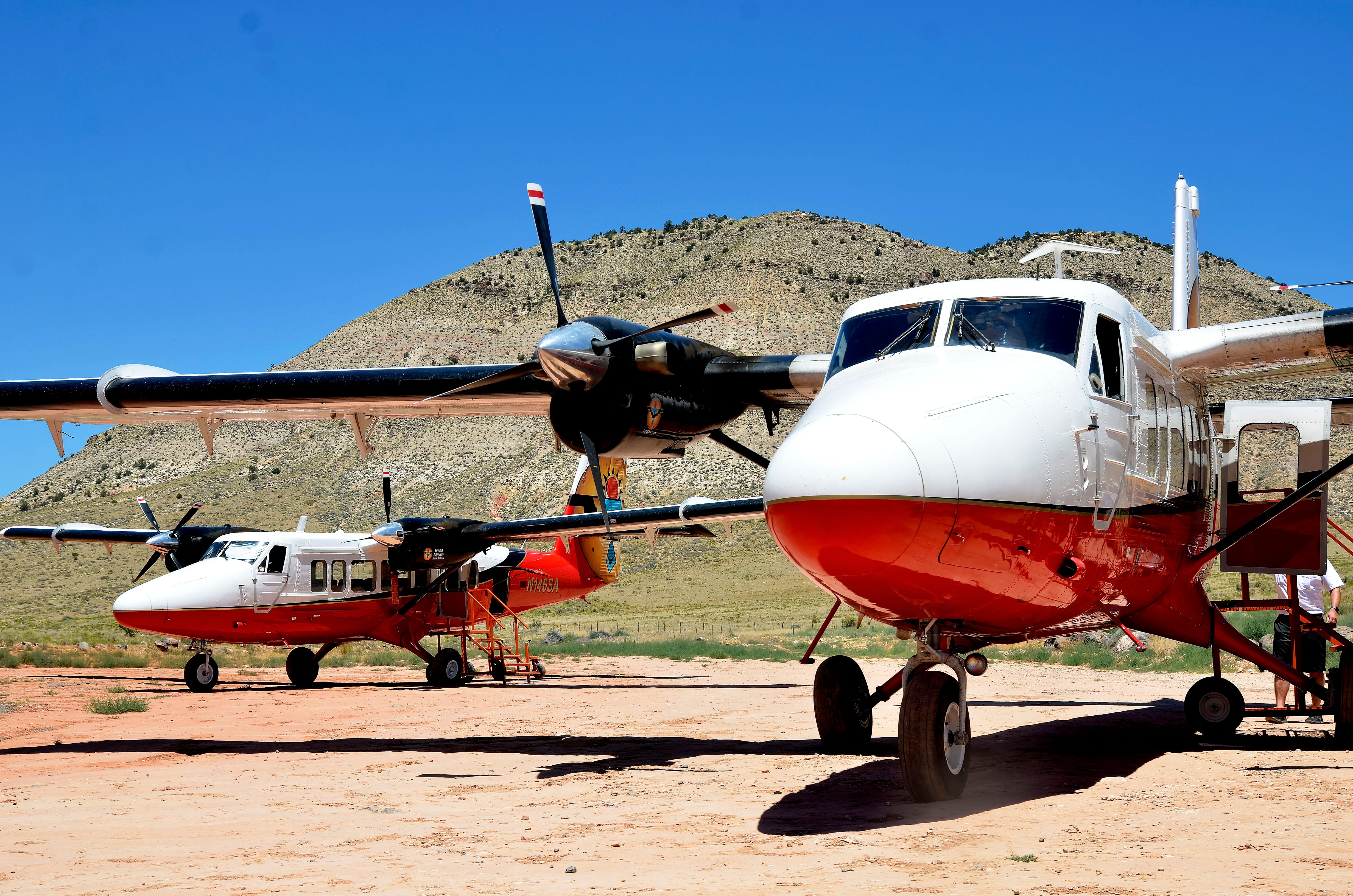 Two Vistaliner Twin Otter airplanes parked at historic Bar 10 Ranch