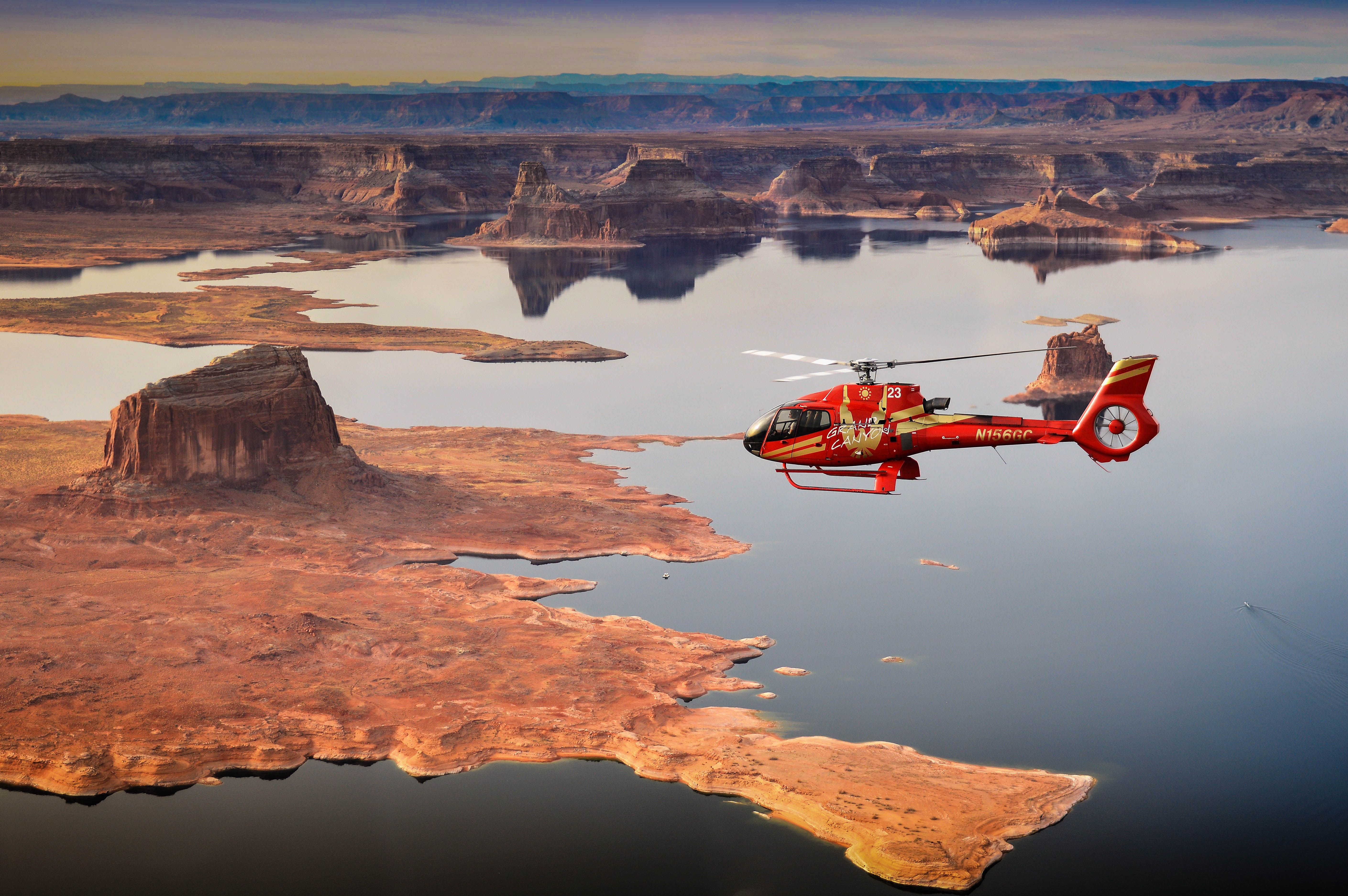 A helicopter tour flies over Lake Powell and rock formations in Page, Arizona
