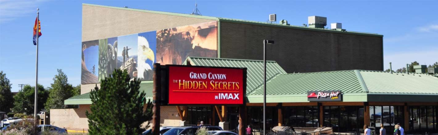 A billboard outside an IMAX theater advertises a Grand Canyon film.